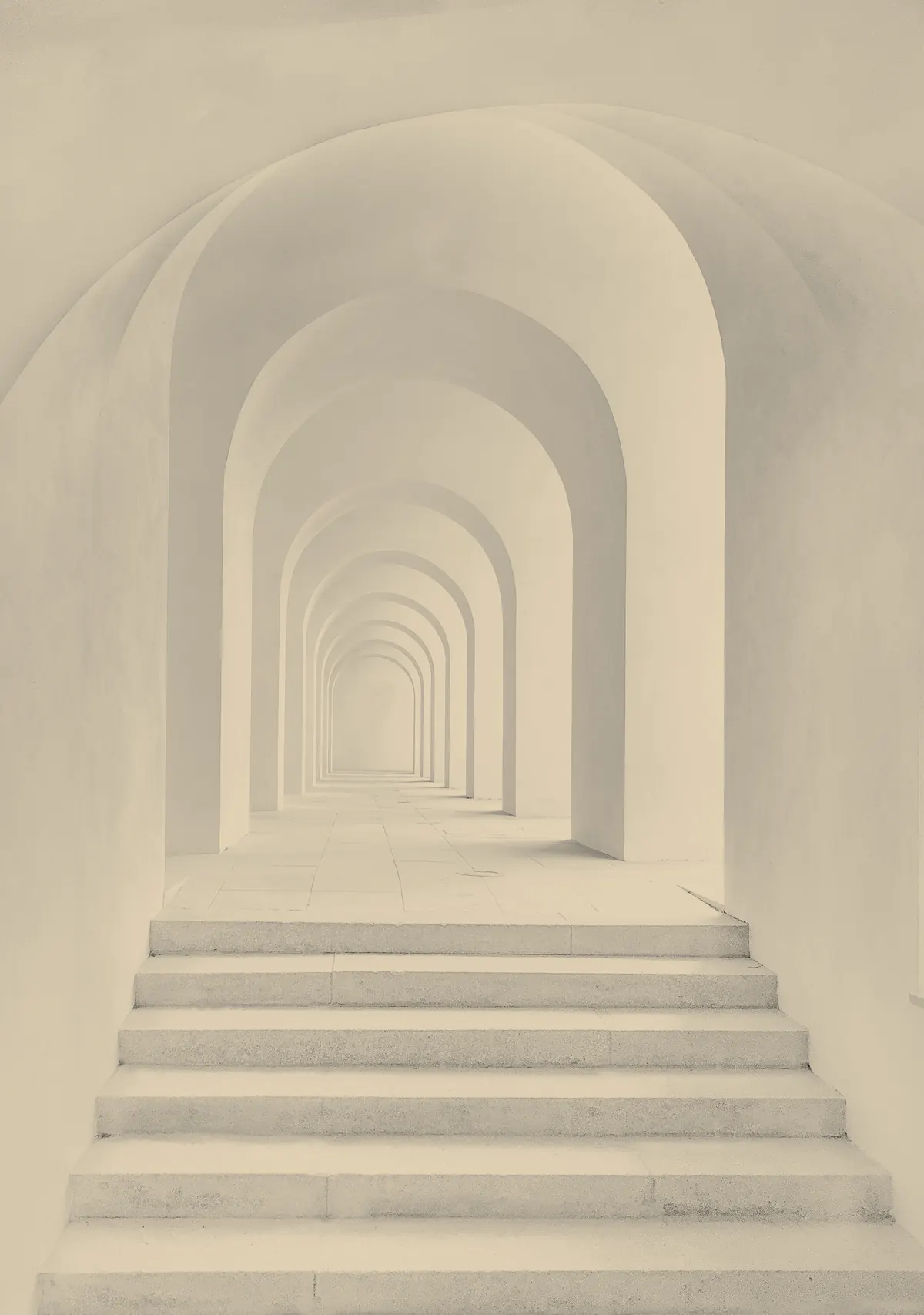 Sunlit stone arches receding along a quiet corridor