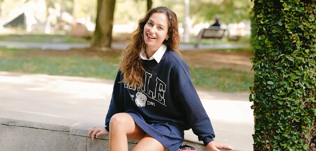 Bayıldım campaign: a smiling woman in a navy sweatshirt sitting in a park